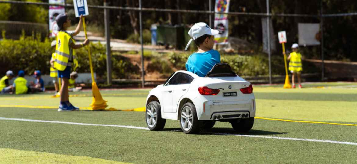 Boy driving a little car